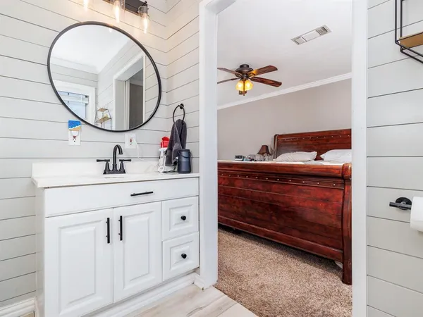 a bathroom with a sink vanity and a mirror