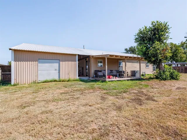a front view of a house with a yard and a garage