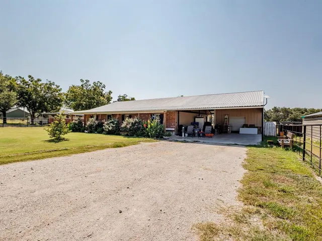 a view of a house with swimming pool and a yard