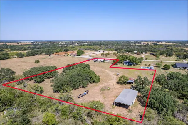 an aerial view of a houses with outdoor space