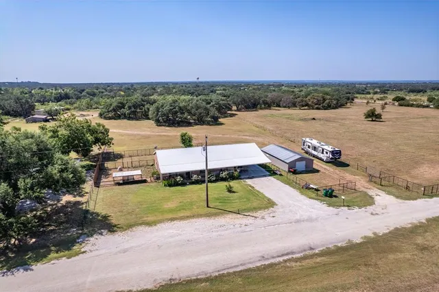 an aerial view of a house with a lake view