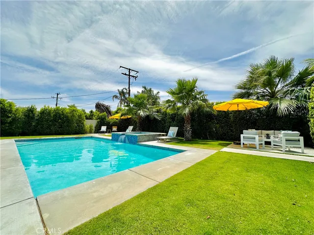 a swimming pool with outdoor seating and yard