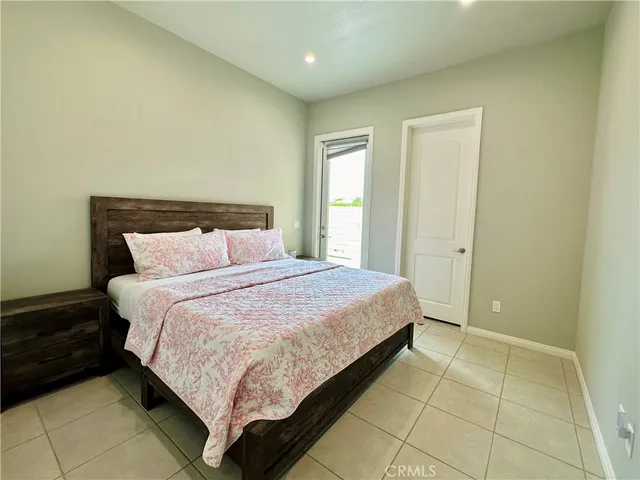 a bedroom with a bed and a mirror