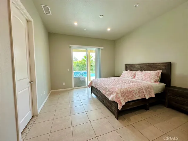 a spacious bedroom with a bed and a window