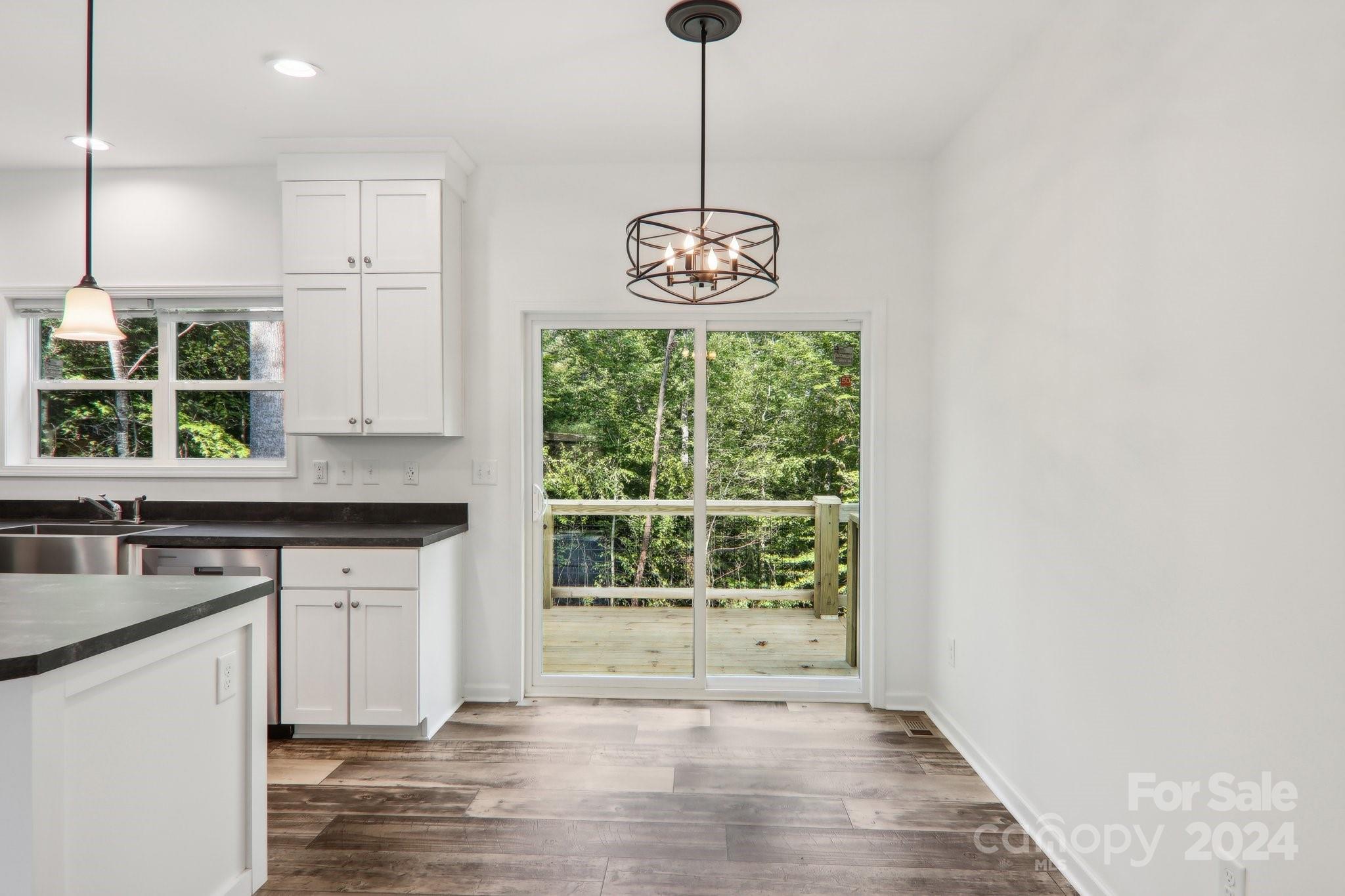 1730 Windswept Ridge Road Marshall, NC 28753 - Photo 14 of 45 a kitchen with granite countertop a stove a sink and a window