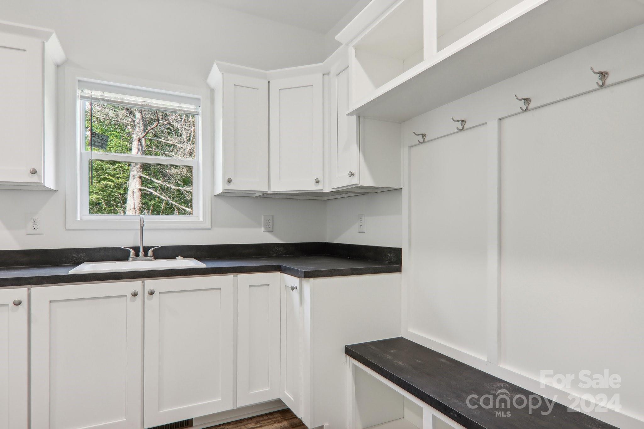 1730 Windswept Ridge Road Marshall, NC 28753 - Photo 16 of 45 a kitchen with granite countertop white cabinets and a sink