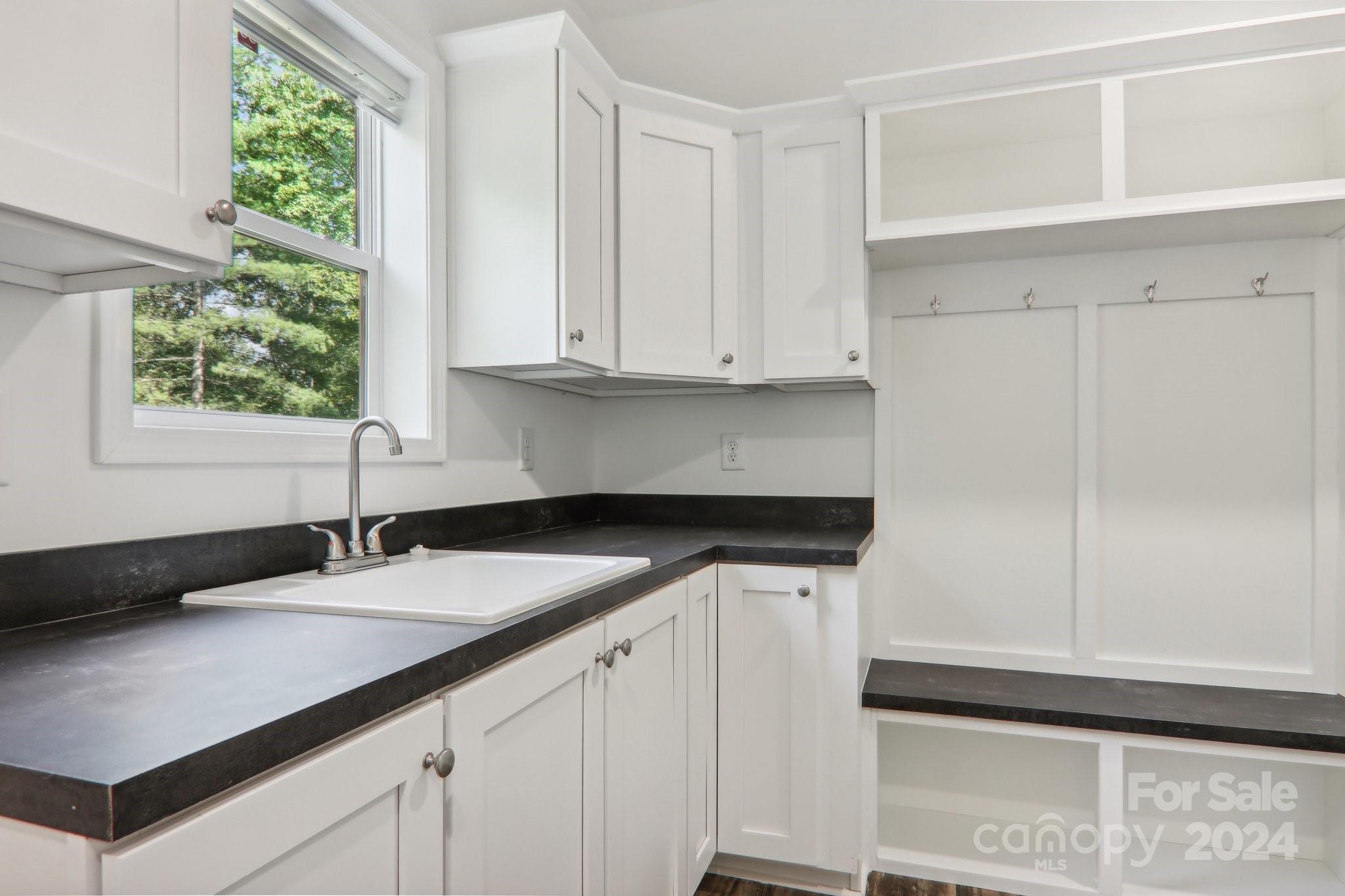 1730 Windswept Ridge Road Marshall, NC 28753 - Photo 17 of 45 a kitchen with granite countertop white cabinets and a sink