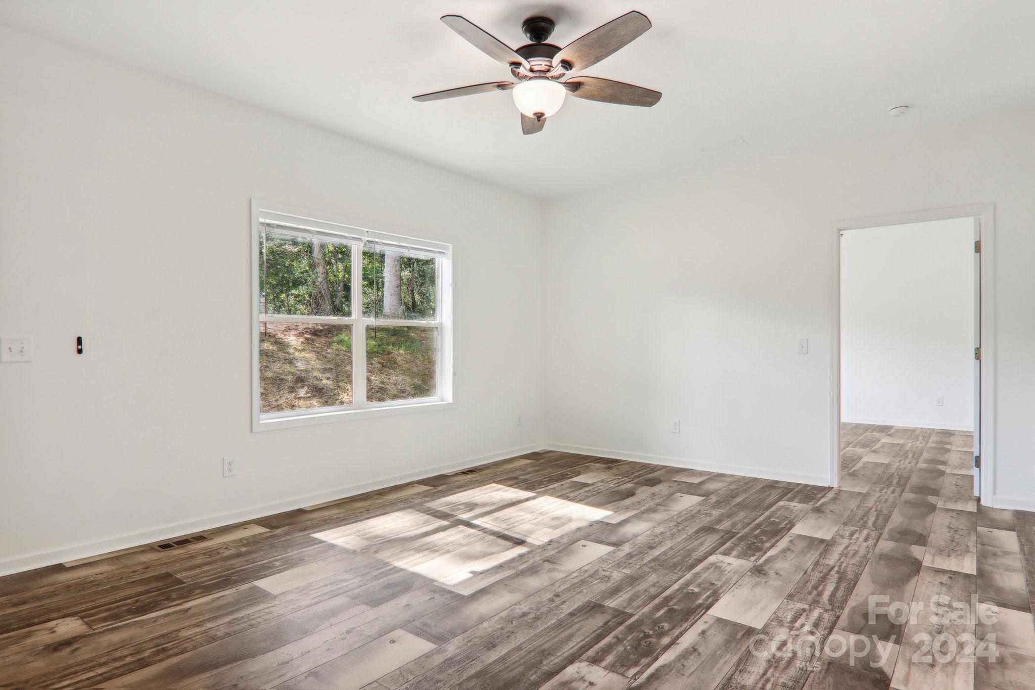1730 Windswept Ridge Road Marshall, NC 28753 - Photo 19 of 45 a view of empty room with wooden floor and fan