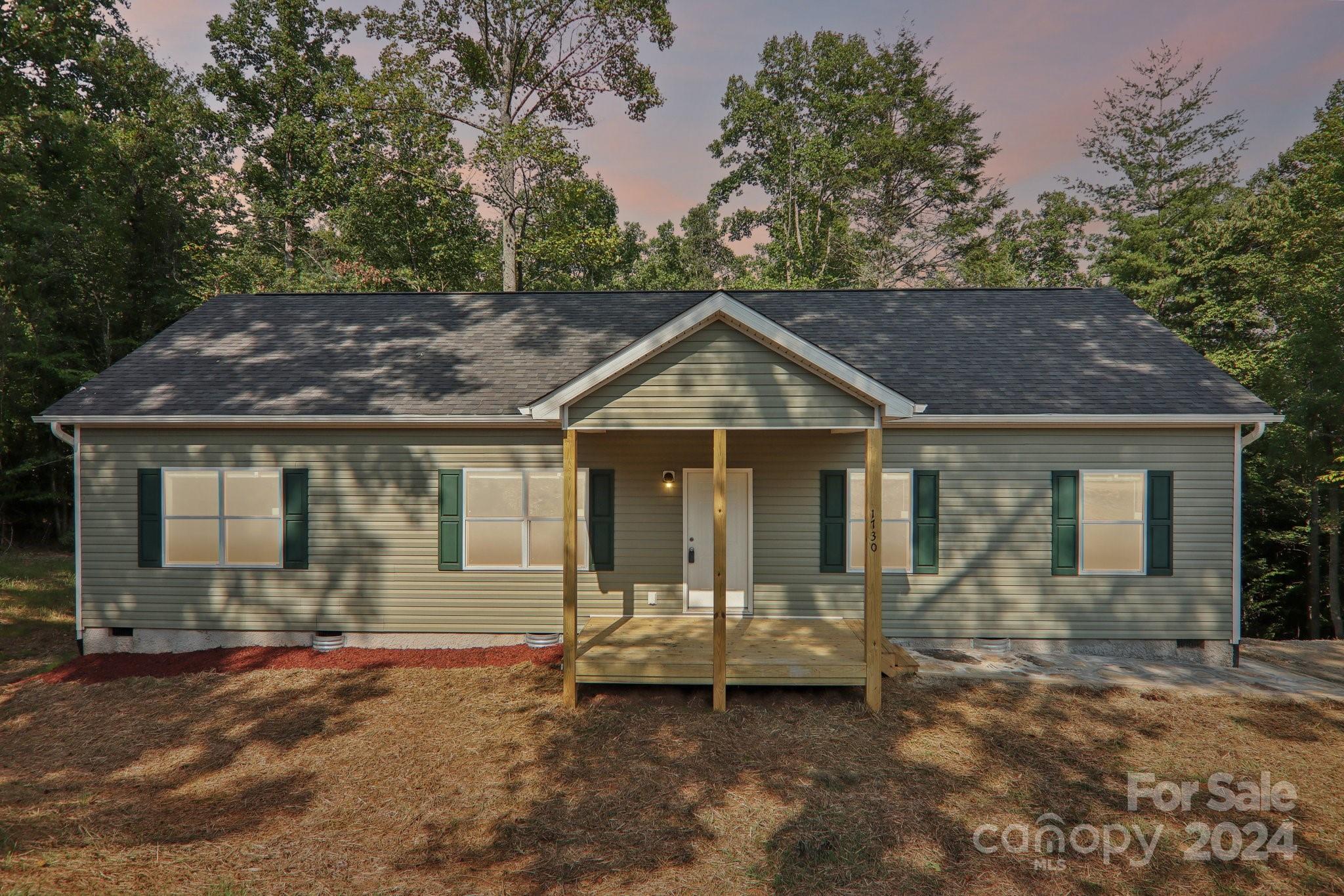 1730 Windswept Ridge Road Marshall, NC 28753 - Photo 2 of 45 a front view of a house with a yard