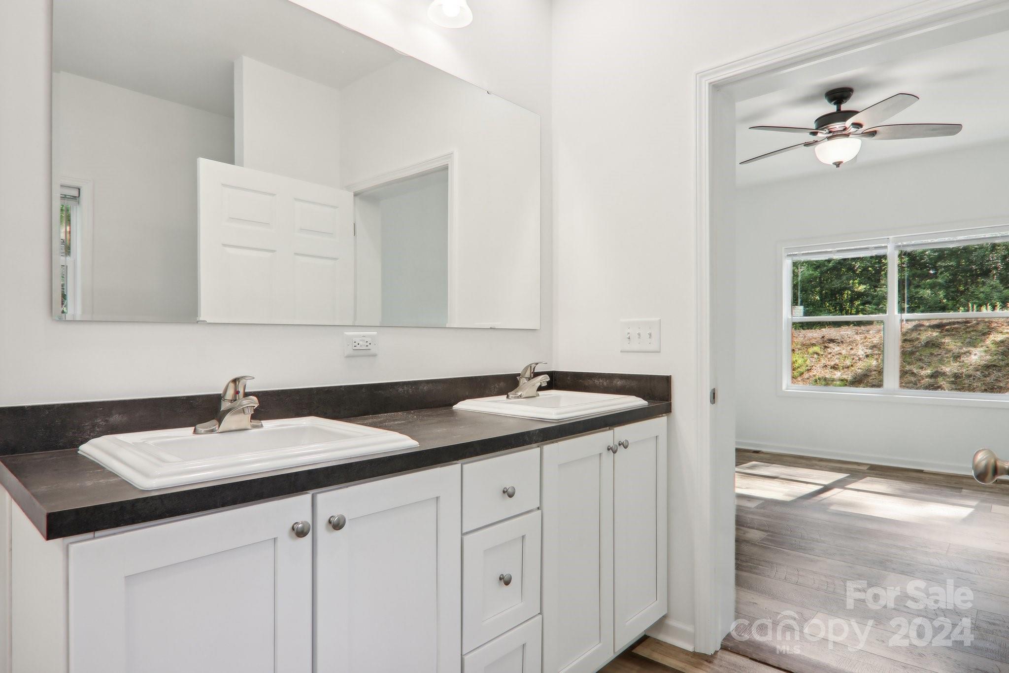 1730 Windswept Ridge Road Marshall, NC 28753 - Photo 25 of 45 a bathroom with a sink and a mirror
