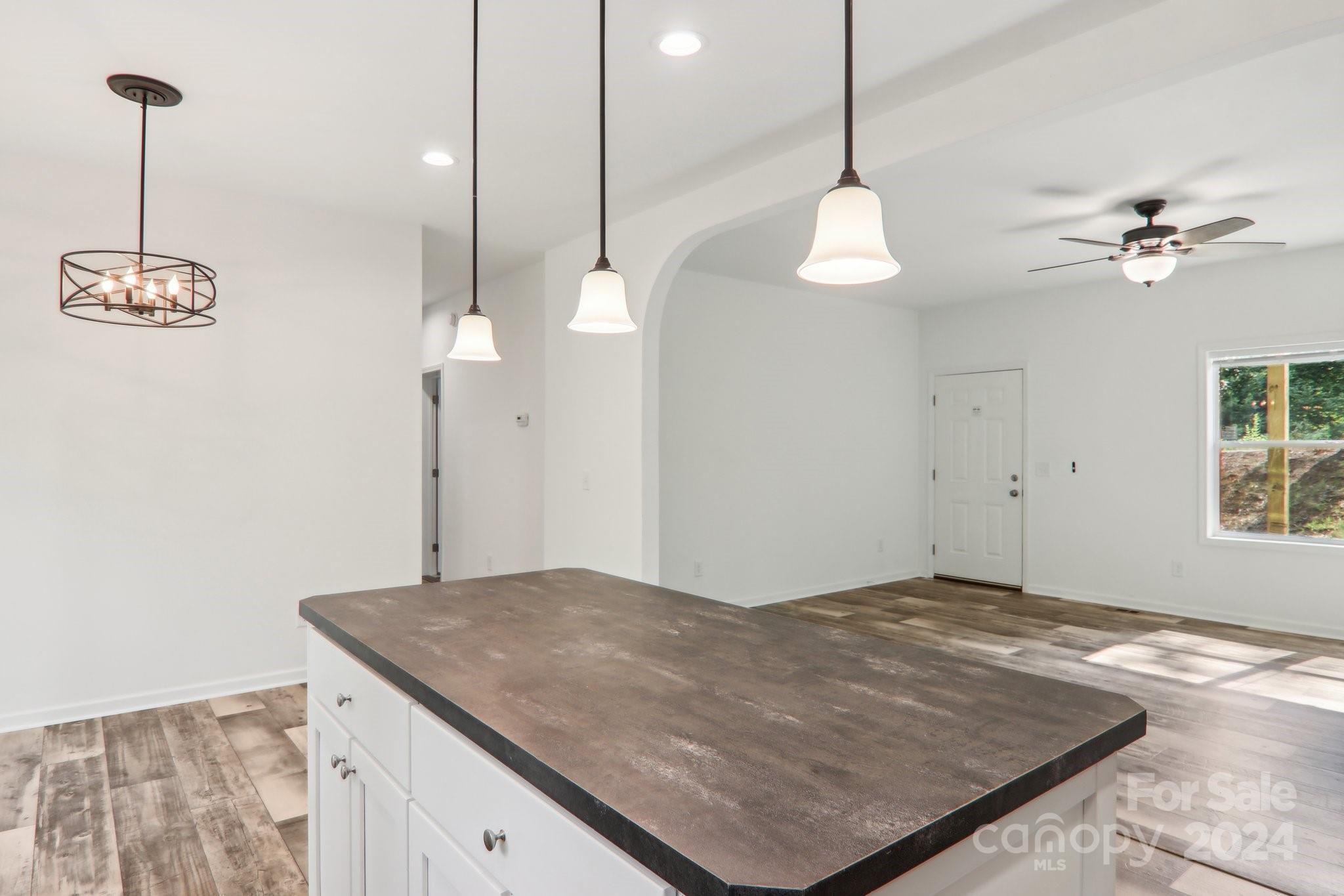 1730 Windswept Ridge Road Marshall, NC 28753 - Photo 26 of 45 a very nice looking room with a chandelier furniture and windows