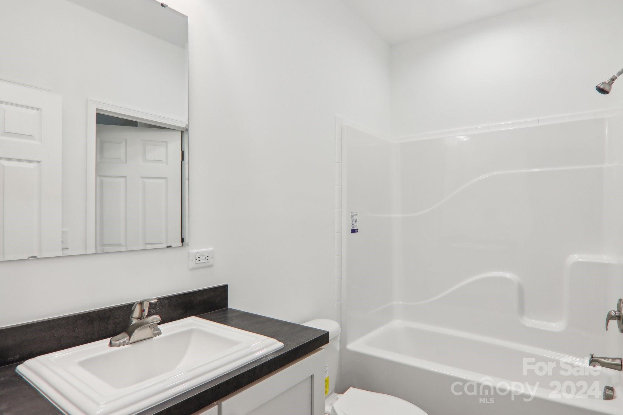 1730 Windswept Ridge Road Marshall, NC 28753 - Photo 28 of 45 a bathroom with a sink a toilet and shower