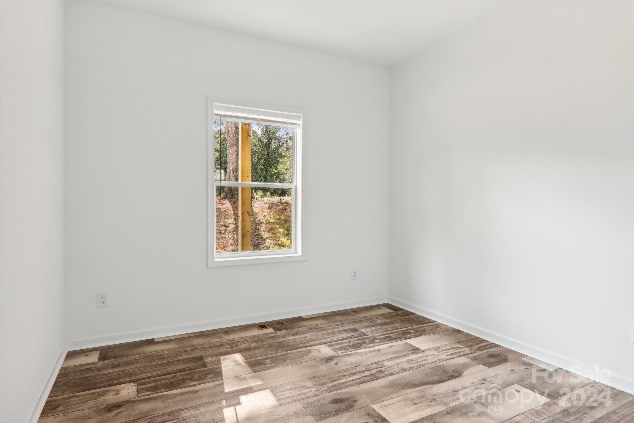 1730 Windswept Ridge Road Marshall, NC 28753 - Photo 30 of 45 an empty room with a window