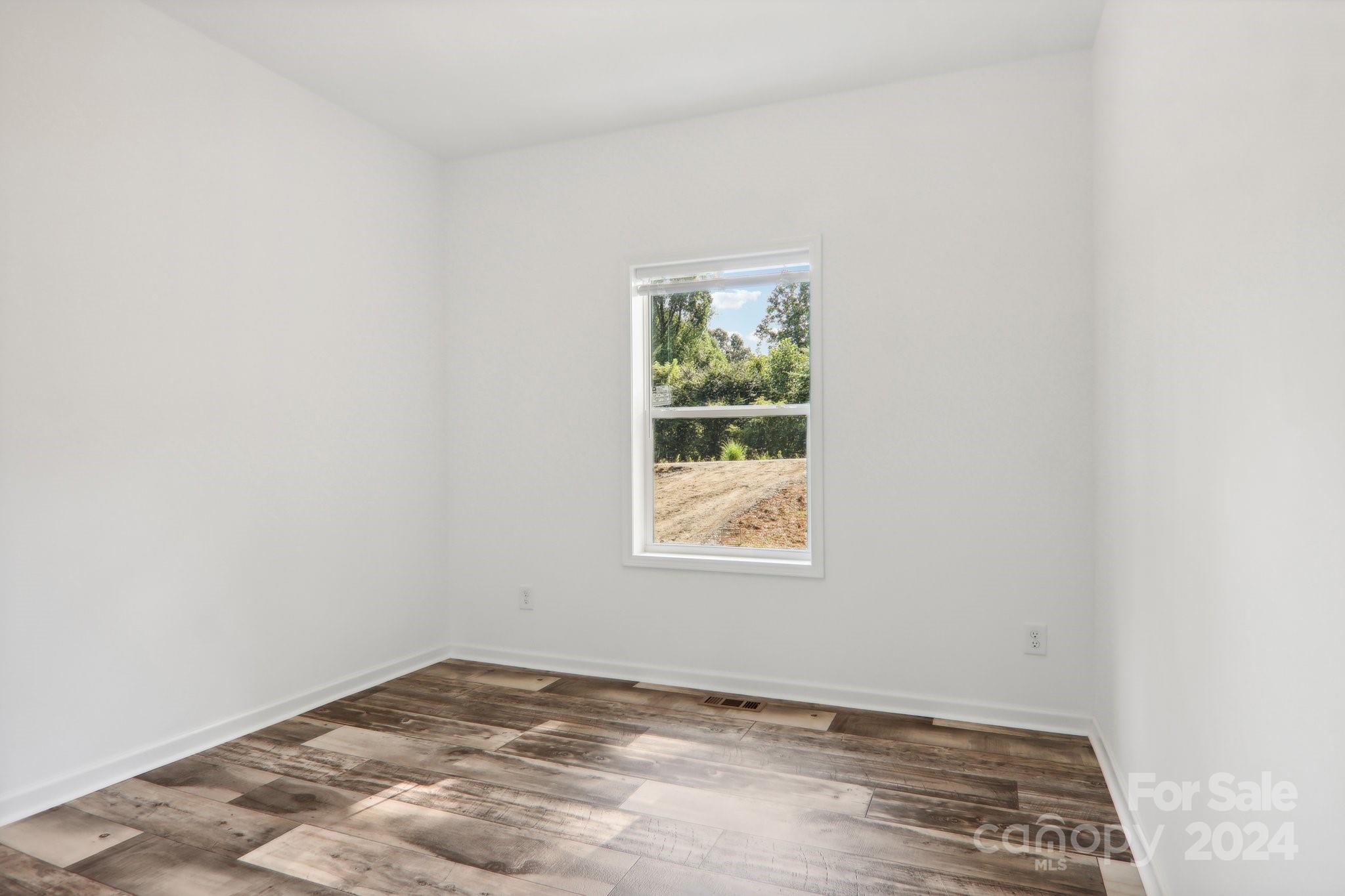 1730 Windswept Ridge Road Marshall, NC 28753 - Photo 32 of 45 an empty room with a window
