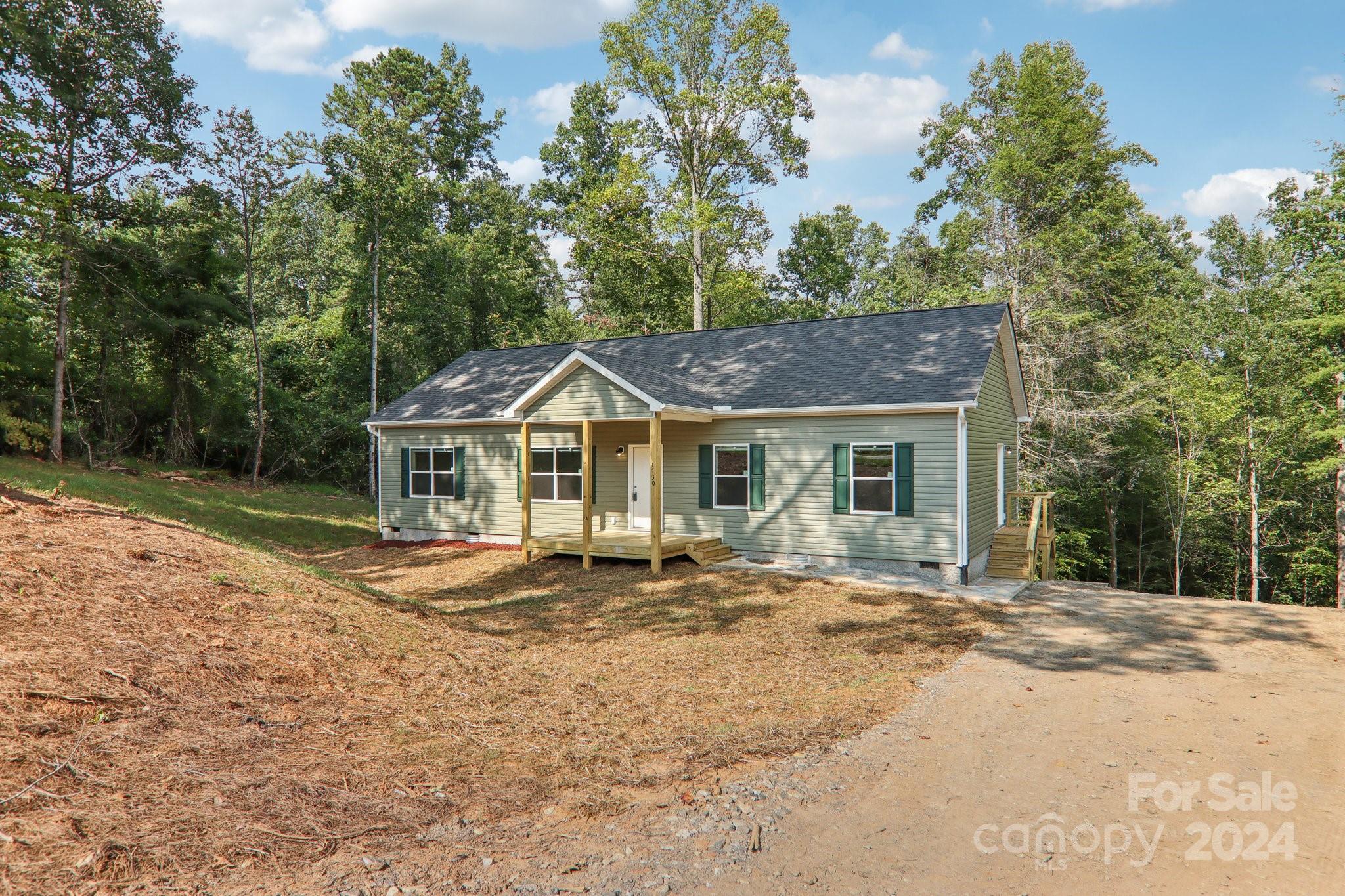 1730 Windswept Ridge Road Marshall, NC 28753 - Photo 7 of 45 a front view of a house with a yard