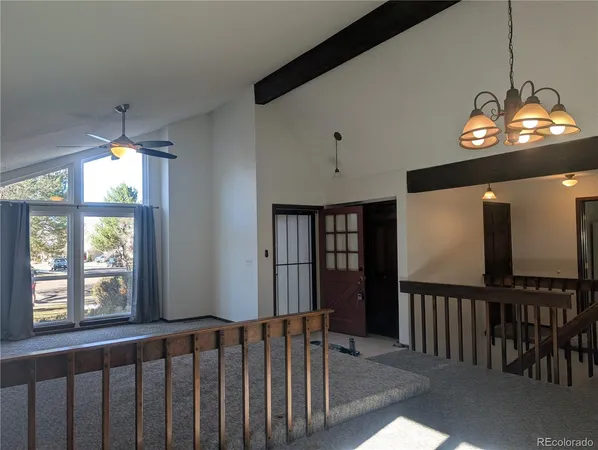 a view of kitchen with furniture and a refrigerator