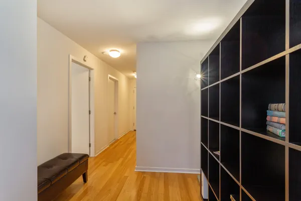a view of a hallway with wooden floor