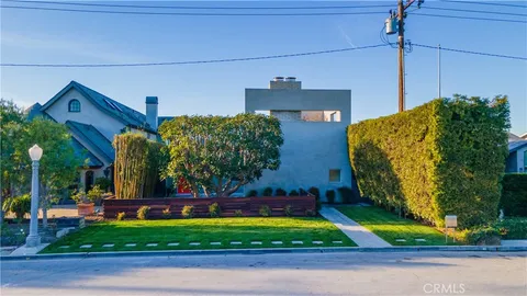 an aerial view of a house with a yard and a pool
