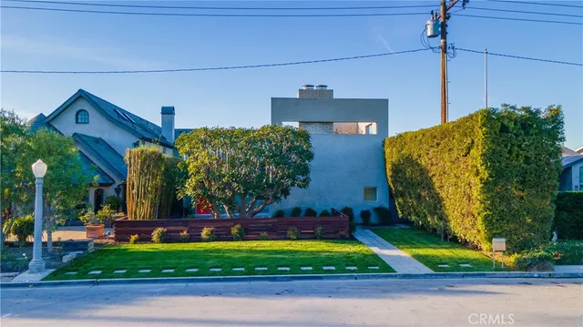 an aerial view of a house with a yard and a pool