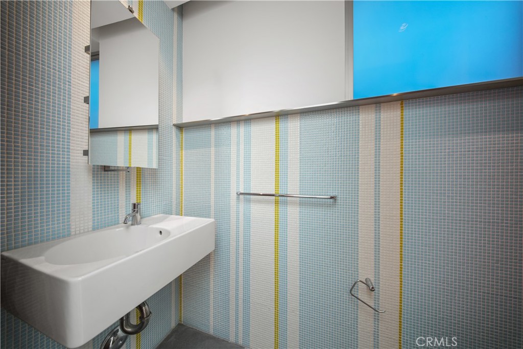 519 Santa Ana Avenue Newport Beach, CA 92663 - Photo 13 of 39 a bathroom with a sink a mirror and a shower