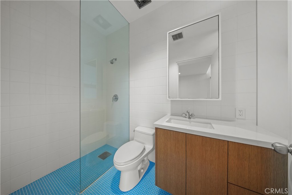 519 Santa Ana Avenue Newport Beach, CA 92663 - Photo 17 of 39 a bathroom with a granite countertop sink toilet and shower