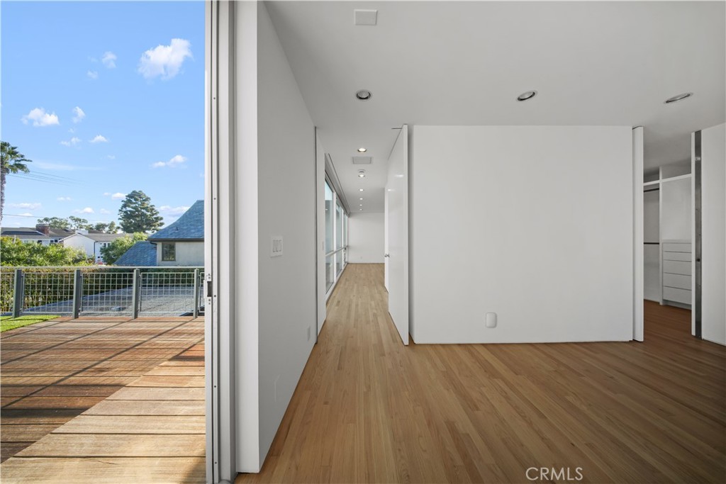 519 Santa Ana Avenue Newport Beach, CA 92663 - Photo 19 of 39 a view of a hallway with wooden floor and staircase