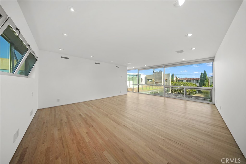519 Santa Ana Avenue Newport Beach, CA 92663 - Photo 23 of 39 a view of an empty room with wooden floor and a window