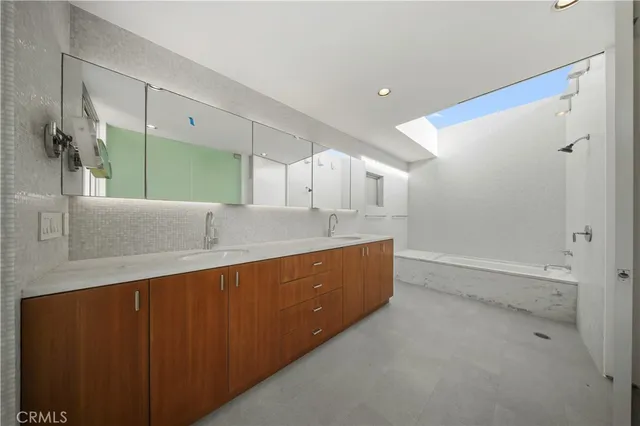 a view of walk in closet with wooden floor