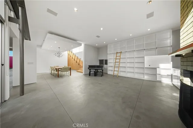 a room with table chairs and wooden floor