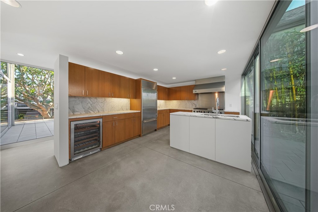 519 Santa Ana Avenue Newport Beach, CA 92663 - Photo 8 of 39 a large kitchen with stainless steel appliances granite countertop a refrigerator and a sink