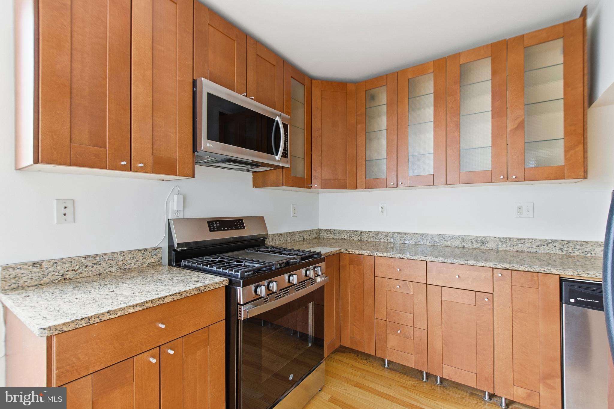 440 Delafield Place Northwest Washington, DC 20011 - Photo 14 of 33 a kitchen with stainless steel appliances granite countertop a stove microwave and cabinets