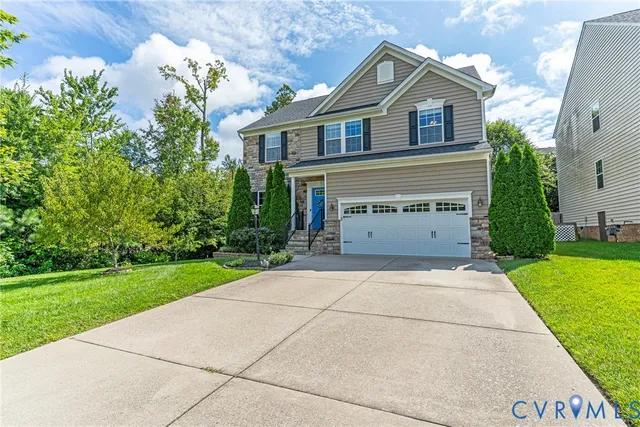 a front view of a house with a yard and garage