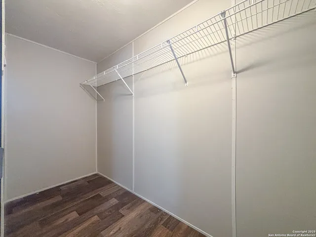 a view of a room with wooden floor