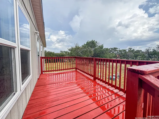 a view of balcony with wooden floor