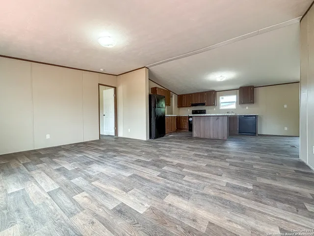 a view of a kitchen with a sink and a refrigerator