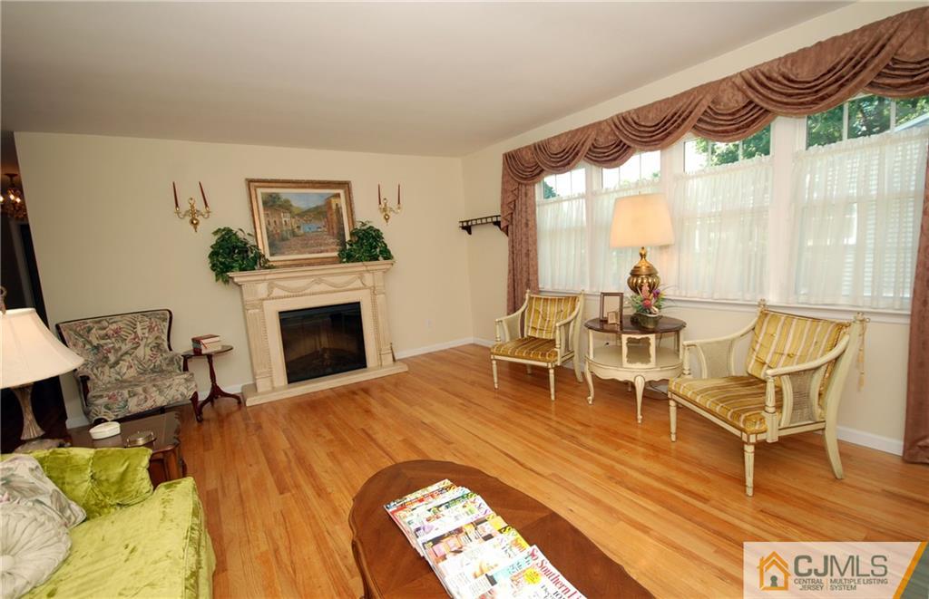 25 Glen Gary Road Middlesex, NJ 08846 - Photo 3 of 21 a living room with furniture a fireplace and a floor to ceiling window