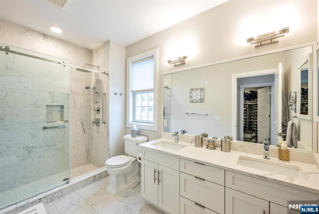 5201 Rio Vista Lane Northvale, NJ 07647 - Photo 18 of 38 a spacious bathroom with a granite countertop sink toilet mirror and shower