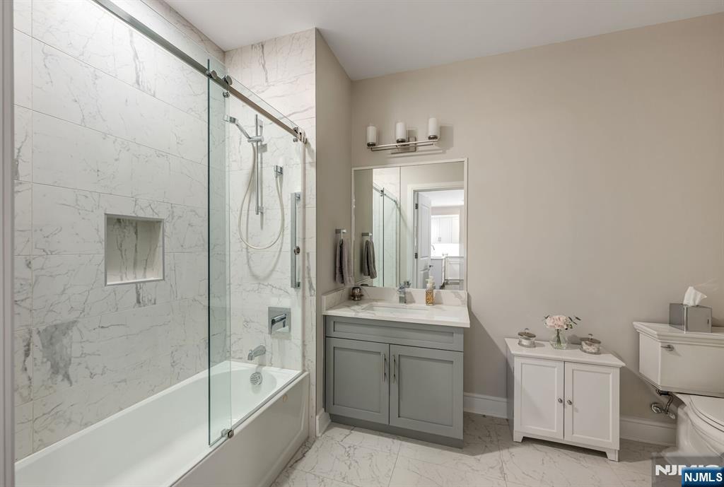 5201 Rio Vista Lane Northvale, NJ 07647 - Photo 22 of 38 a bathroom with a bathtub a mirror a sink and vanity