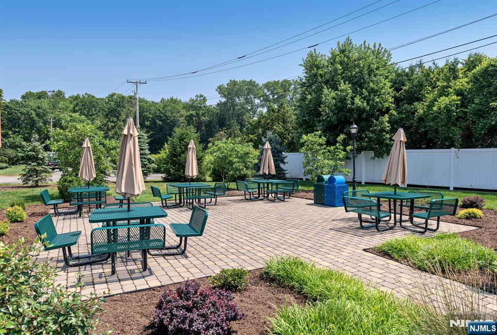 5201 Rio Vista Lane Northvale, NJ 07647 - Photo 34 of 38 a view of a patio with table and chairs potted plants and large tree