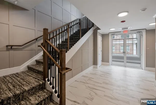 a view of entryway and hall with wooden floor