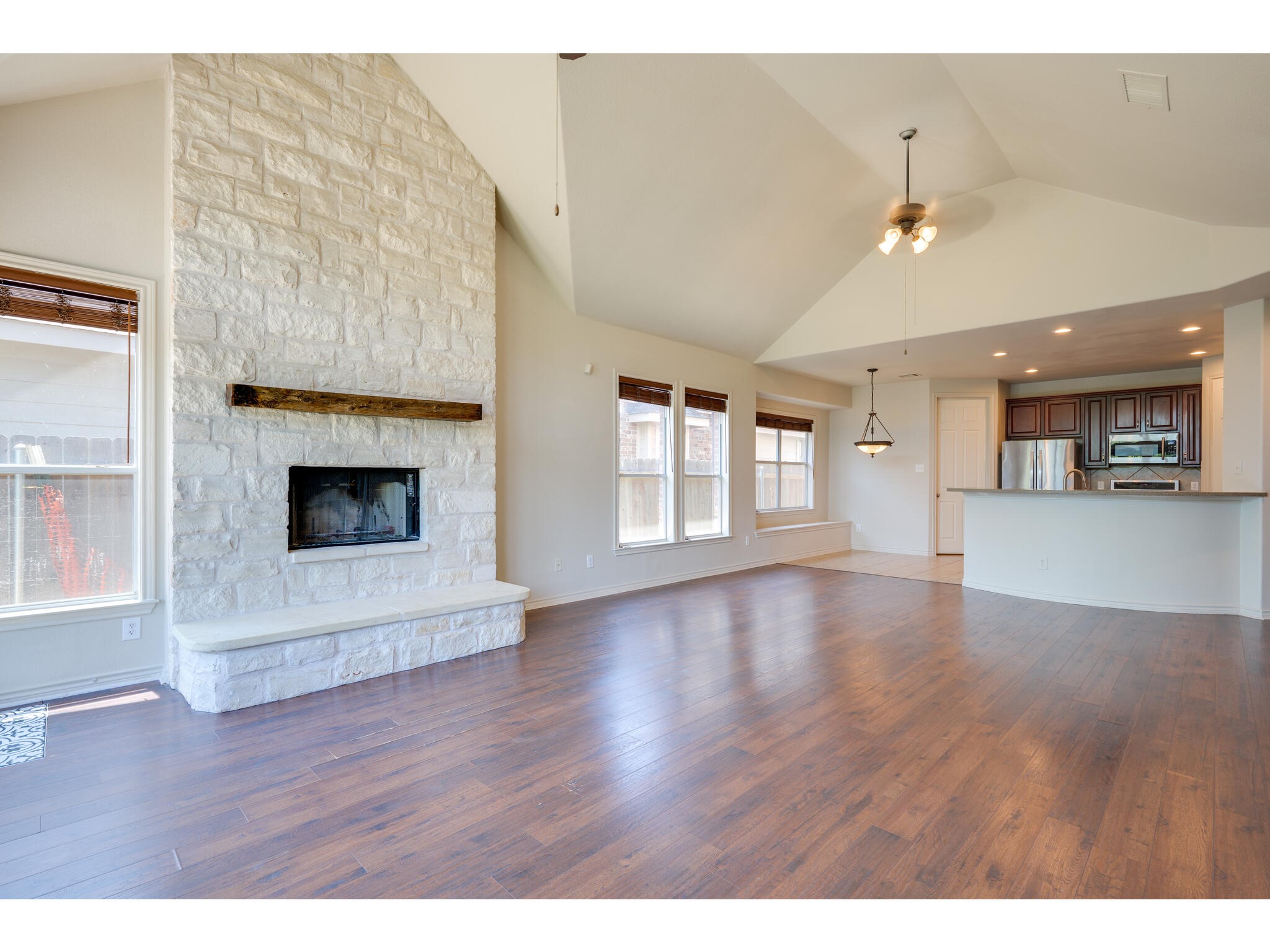 13925 Fallsprings Way Manor, TX 78653 - Photo 2 of 39 a view of a livingroom with wooden floor and a fireplace
