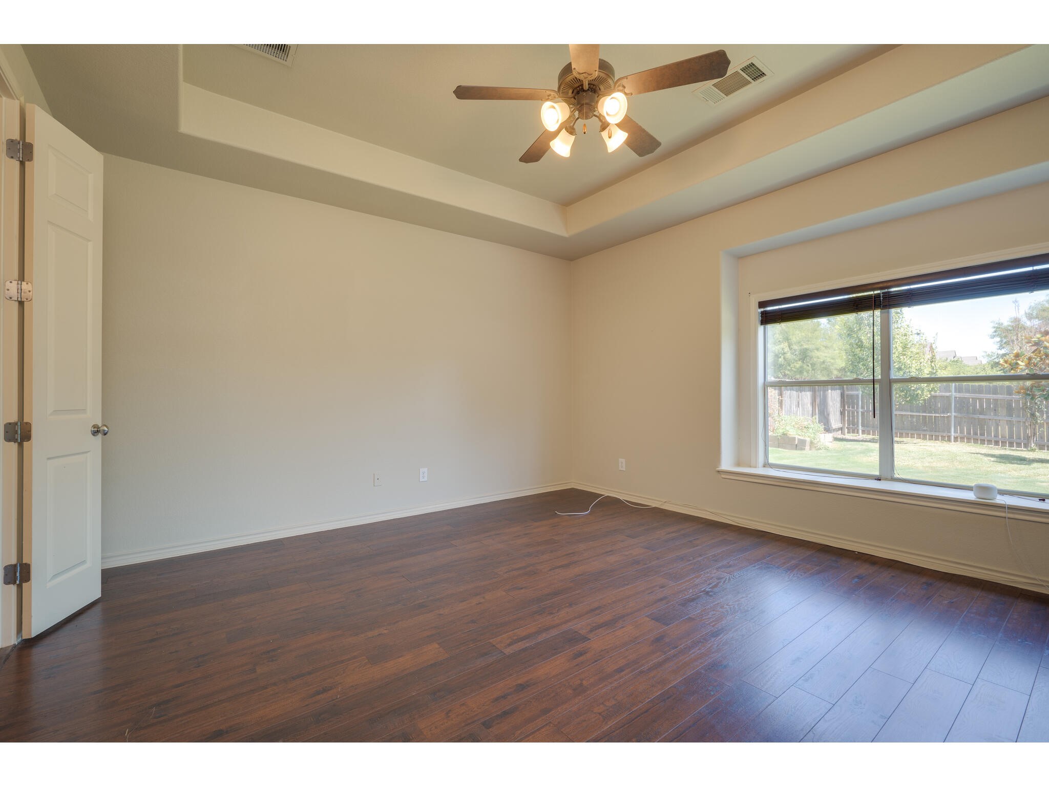 13925 Fallsprings Way Manor, TX 78653 - Photo 22 of 39 an empty room with wooden floor and windows