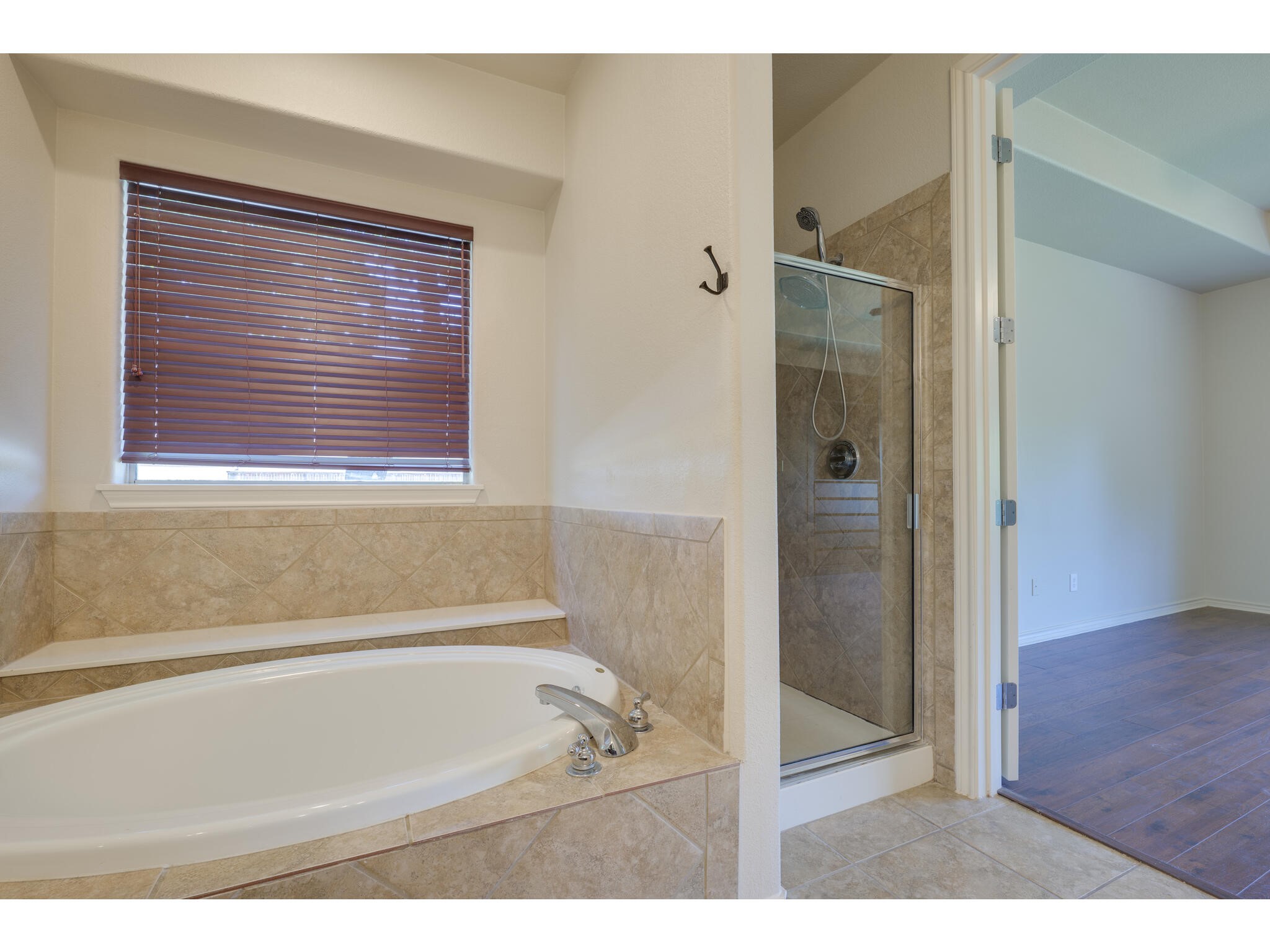 13925 Fallsprings Way Manor, TX 78653 - Photo 25 of 39 a bathroom with a bathtub and a shower
