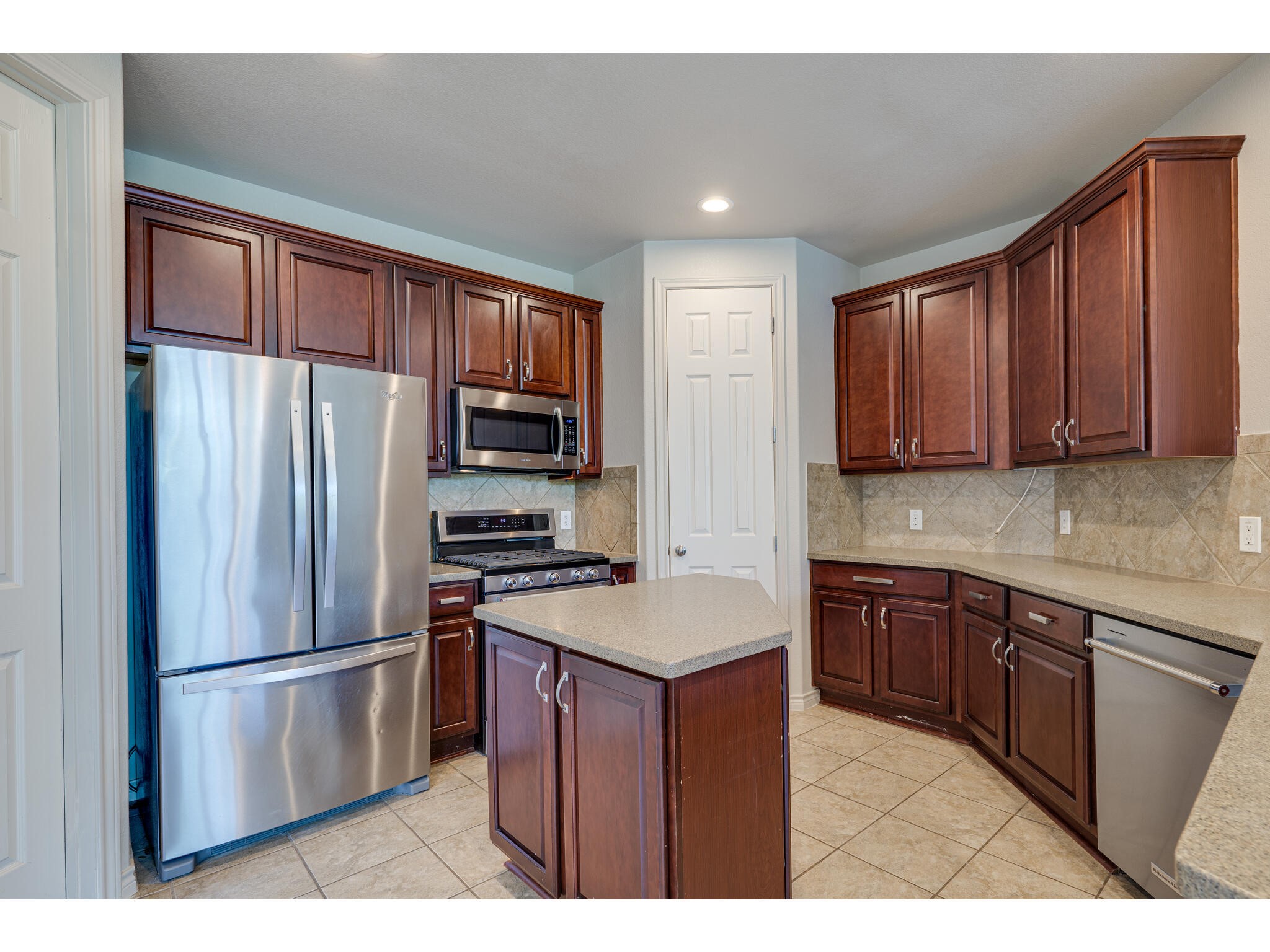 13925 Fallsprings Way Manor, TX 78653 - Photo 3 of 39 a kitchen with a refrigerator sink and microwave