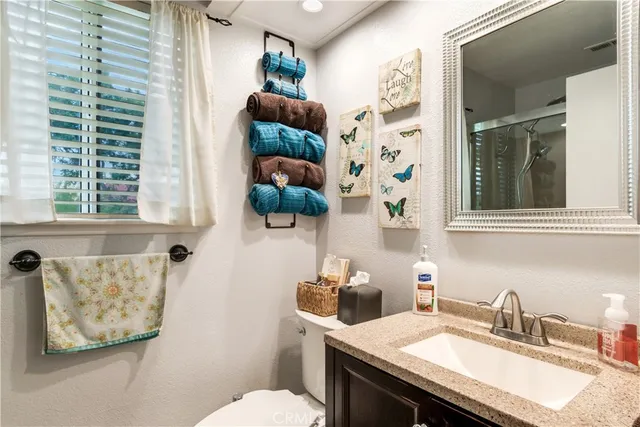 a bathroom with a sink granite and a toilet