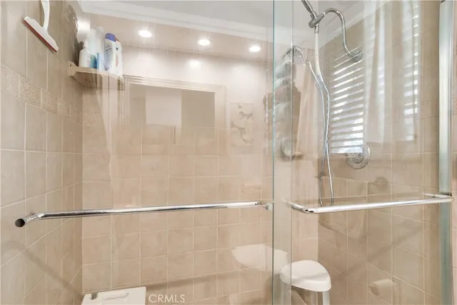 a bathroom with a shower and a glass door shower