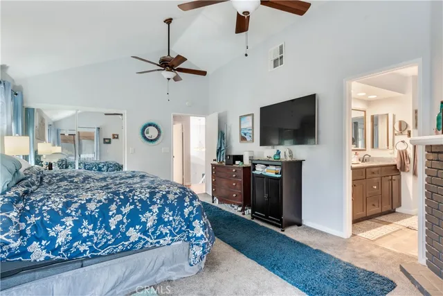 a bedroom with a bed and a flat tv screen on dresser