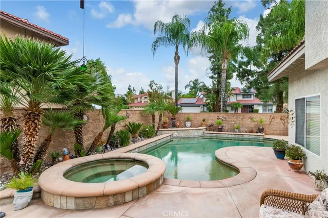 a view of a backyard with swimming pool
