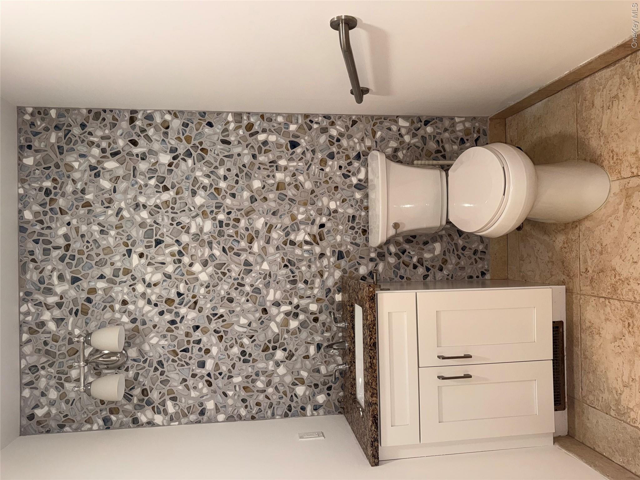 1661 Old Country Road, Unit 516 Riverhead, NY 11901 - Photo 30 of 50 a bathroom with a toilet and a sink