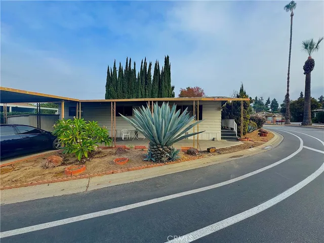 a view of a house with outdoor space and sitting area